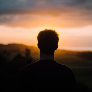 silhouette of a man facing the sunset